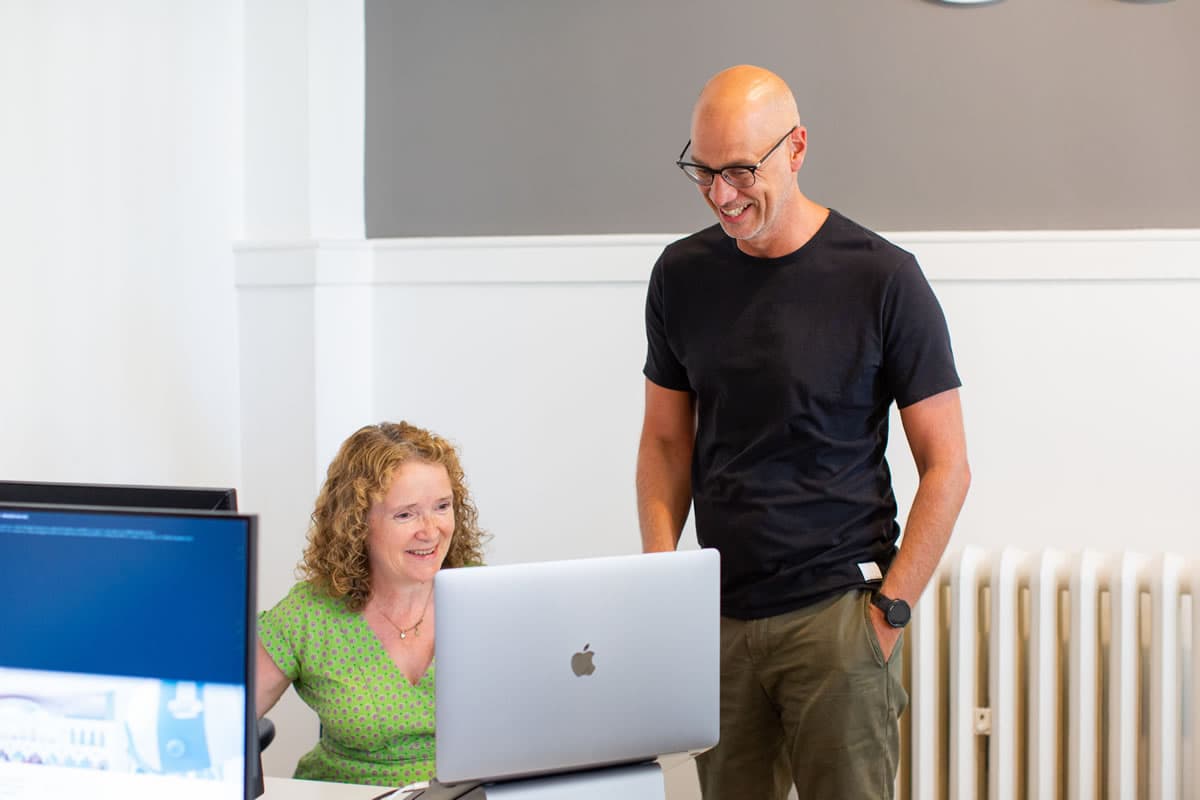 Delyth and Lee looking at a laptop